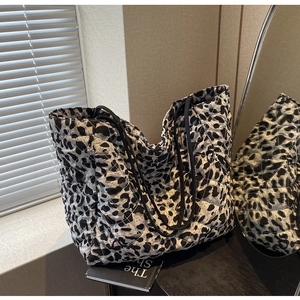 Detail of quilted texture and black and white leopard print on the large tote bag