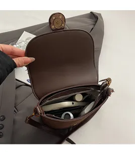 Detailed view of the spacious interior compartment of this brown saddle bag
