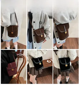Mini suede bucket bag with metal bear detail shown on model in multiple colors