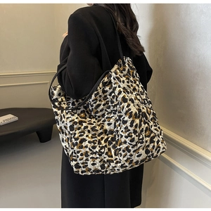 Quilted leopard print tote bag with spacious interior shown on a model's shoulder