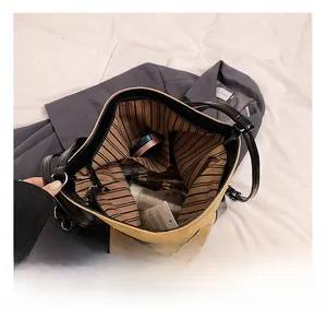 Interior view of suede tote bag showing large capacity for cosmetics and inner pockets
