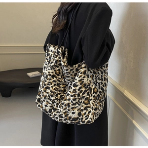 Close-up of quilted leopard print tote bag with soft texture and slim black straps