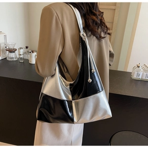 Detail of hobo shoulder bag with contrast black and silver metallic texture and drawstring