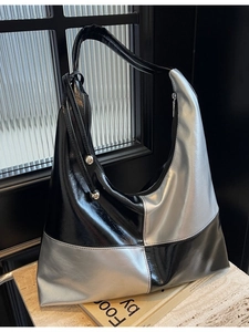 Fashionable black and silver checkerboard tote bag with glossy finish and metal details