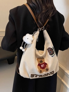 Beige tote hobo bag with teddy bear patch embroidery and adjustable brown leather strap