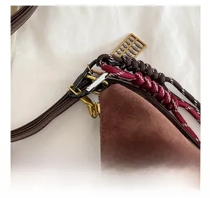 Detail of brown suede tote with silver carabiner and golden mini abacus keychain charm