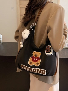 Large black canvas tote bag with teddy bear embroidery and brown leather shoulder straps