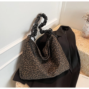 Detail der Leopard-Tragetasche mit schwarzem gerafftem Schultergurt auf einem Blazer