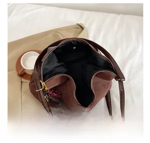Top view of deep brown frosted tote bag showing interior space and colorful charm