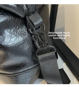 Detail of the detachable matte black metal hook and strap on black wrinkled leather bag