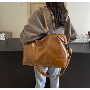 Brown vintage faux leather travel bag with large capacity and shiny texture for women