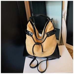 Detail of camel suede and black leather hobo bag with woven drawstring and knot