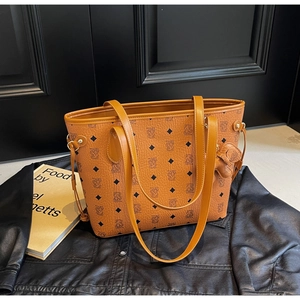 Détail d'un sac cabas marron avec motifs d'ours et un porte-clé ours en peluche