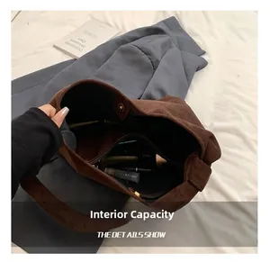 Interior view showing the large capacity and zipper pocket of this brown suede tote bag
