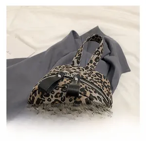 Close-up of leopard print backpack showing durable fabric and comfortable handle strap