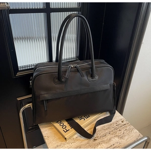 Nahaufnahme der schwarzen Nylon- und Reisetasche auf Steinfläche vor Glas hintergrund