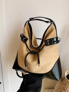 Minimalist large khaki suede tote bag with black contrast straps and knot detail