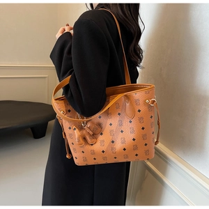 Détail du sac cabas en cuir marron avec motifs d'ours et cordon de serrage décoratif