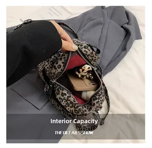 Macro view of leopard print backpack with red lining showing large interior capacity