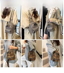 Detail view of mini leopard print backpack showing zipper pocket and fabric straps