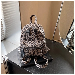 Detailed view of trendy leopard print mini backpack in durable canvas with front pocket