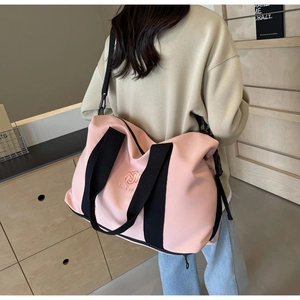 Vue arrière d'un mannequin portant un grand sac de voyage rose dans un décor minimaliste