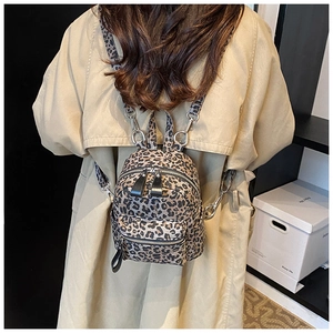Detailed back view of mini leopard print backpack with adjustable metal buckles