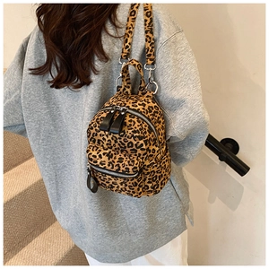Detail of mini leopard print backpack on model showing size and soft fabric texture
