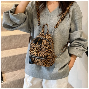 Detail view of mini leopard print backpack with silver zippers and removable strap