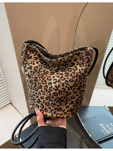 Retro leopard print bucket bag with adjustable shoulder strap and gold coin charm