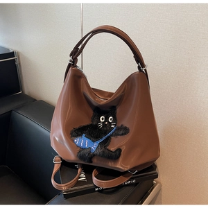 Détail d'un sac cabas marron en PU avec chat en peluche 3D et fermeture éclair métallique