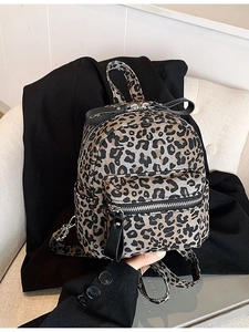 Fashionable leopard print mini backpack with black bow detail and silver zippers