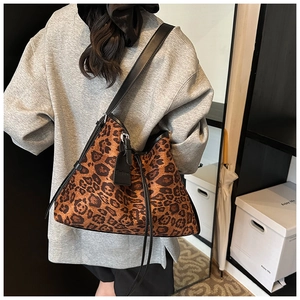 Detail of leopard print tote bag with black leather straps and Fashion engraved tag