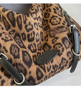 Dettaglio ravvicinato della trama leopardata e delle finiture in metallo argentato della borsa