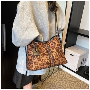 Close-up of leopard print tote bag featuring a black shoulder strap and Fashion tag