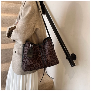 Detailed view of leopard print tote bag with drawstring closure and fashion tag