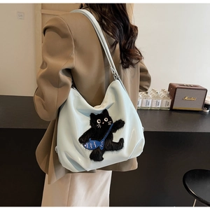 Détail du sac fourre-tout bleu clair avec broderie chat noir sur une surface en cuir PU poli
