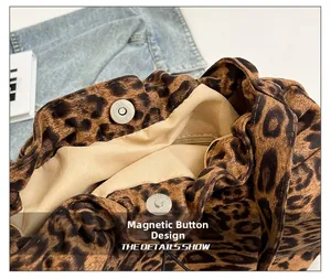 Detail view of the silver magnetic snap closure on the leopard print tote bag