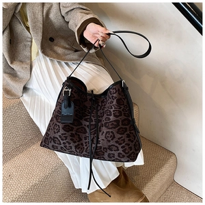 Detailed view of large leopard print tote bag with black leather Fashion tag and straps