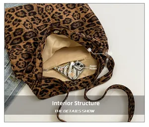 Detail of leopard print tote bag interior featuring main pocket and a zipper compartment