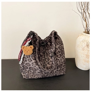 Leopard print bucket bag detail with drawstring closure and cute plush bear charm
