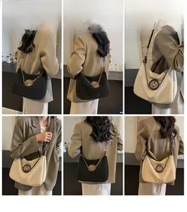 Model display of large chain shoulder bag in black and beige with metallic M logo