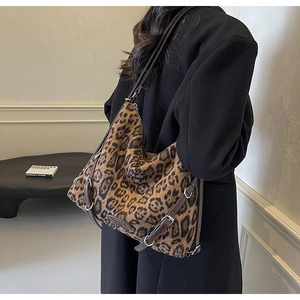 Dettaglio borsa shopper leopardata con tracolla in pelle marrone e fibbia in metallo argentato