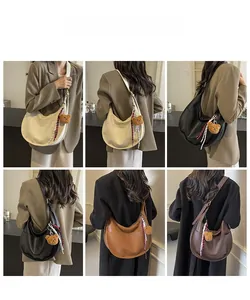 Three minimalist Hobo shoulder bags in cream, black, and brown with cute bear charms
