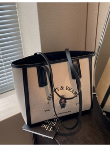 Minimalist canvas tote bag with black leather trim and cute bear print for daily use