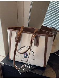 Large cream canvas tote bag with brown leather trim and bear print for commuting