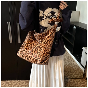 Detail of hobo bag with leopard print canvas and unique knotted strap attachment