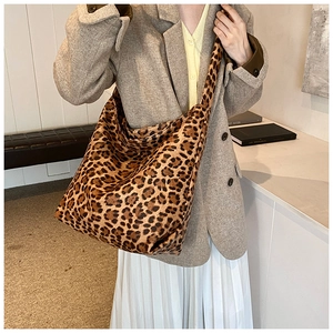 Detailed view of vintage leopard print tote bag styled on a khaki blazer outfit