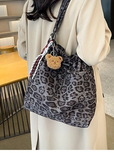 Chic leopard print bucket bag for women with a plush bear charm in a spacious design