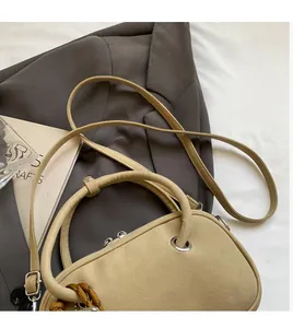 Vue détaillée du sac à main en cuir mat kaki avec poignée ronde et bandoulière
